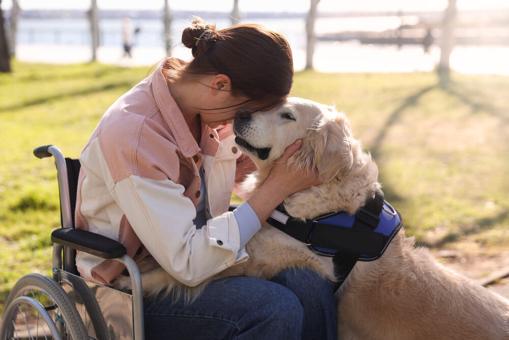 Woman embracing her emotional support dog outdoors